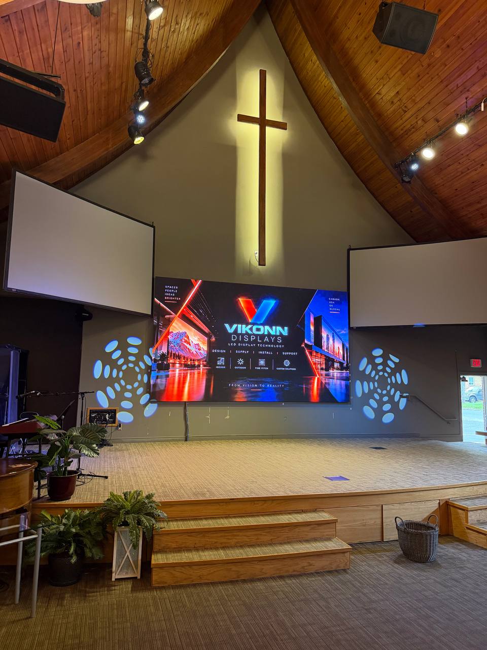 Church stage with an LED wall and two side screens